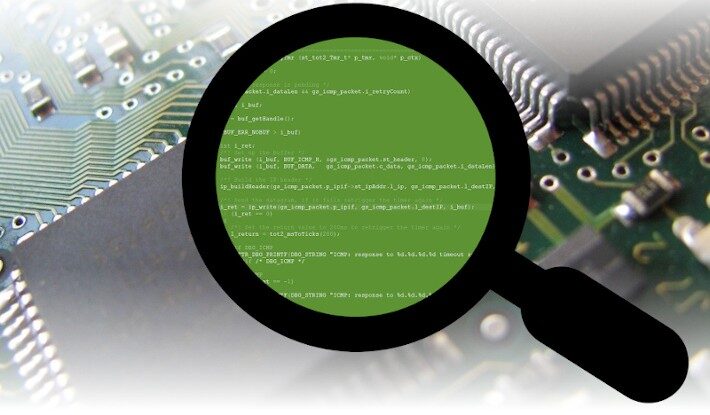 Magnifying glass showing source code over a microchip, representing embedded software in IoT devices.